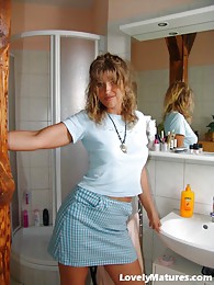 Enticing mature Maike stripping in the bathroom